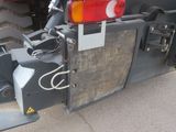a close up of a tractor with a red light on the back of it