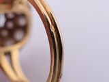 a close up of a gold ring with a diamond in it