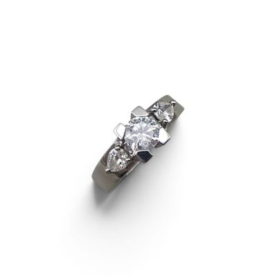 an image of a diamond three stone ring on a white background