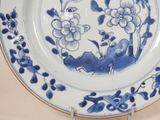 a blue and white plate with flowers on it