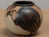 a black and white vase with a bird on it