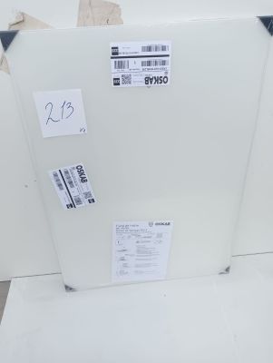 a white refrigerator sitting on the floor in a room