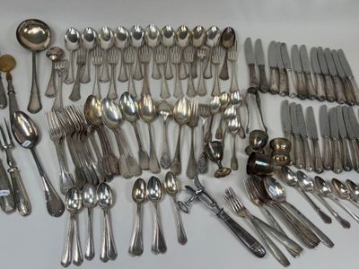 a lot of silver spoons and spoons on the table