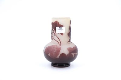 a small vase with a red and white design on it