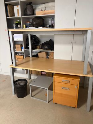 a desk with two drawers and a cabinet in the room