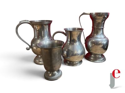 three silver vases sitting next to each other on a white surface