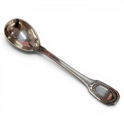 silver spoon on a white surface with a silver handle