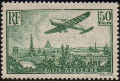 an old stamp with a picture of a plane flying over a city