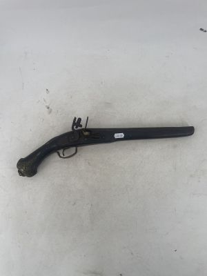 an old gun that is laying on the ground in the snow