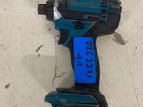 a close up of a cordless drill with a blue label on it