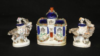 three porcelain figurines of horses and a man on a horse