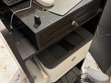 a laptop computer sitting on top of a drawer next to a keyboard