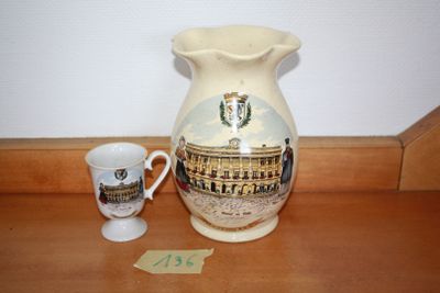 a vase and a cup sitting on a table
