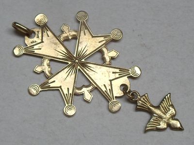a gold star shaped pendant with a bird on it