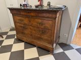 a dresser in the corner of a room with a black and white checkered floor