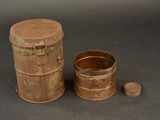 a small metal container with a lid next to a smaller metal container