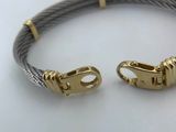 a close up of a bracelet with two clasps on a plate