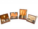 several silverware items are in a wooden case on a white surface