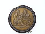 an image of a gold coin with a picture of a man and a woman on it