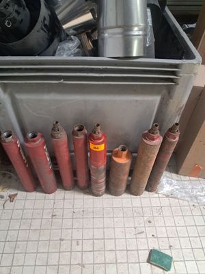 many different types of propane gas cylinders in a bin