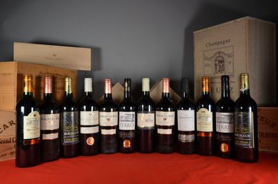 many bottles of wine sitting on a table with a red cloth