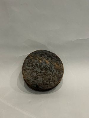 an old wooden box with a train on it sitting on top of a white surface