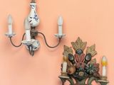 two wall sconces that are hanging on the wall