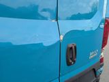 a close up of a blue truck with the door open