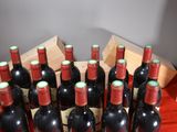 many bottles of wine sitting in a wooden crate