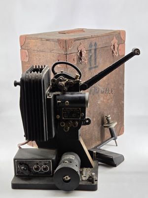 an old camera sitting on top of a wooden box