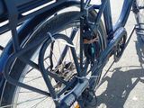 a blue bike parked on the side of the road