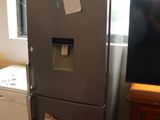a refrigerator and a washing machine in a small room