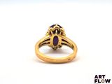 an image of a gold ring with a purple stone