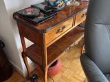 a table with a vase on top of it next to a chair