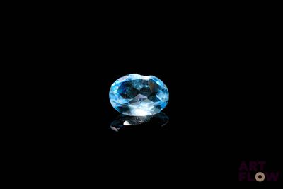 a close up of a blue topaz stone on a black surface