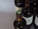 several bottles of wine are lined up on a table