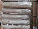 a stack of boxes and a pallet full of mattresses