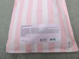 a pink and white bag with a pink stripe pattern on it