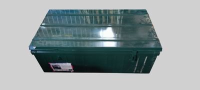 an image of a green metal box with a lid and a sticker on it