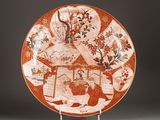 a red and white plate with flowers and birds on it