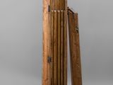 an image of a tall wooden clock with a wooden case on top