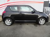 a picture of a small black car parked in a parking lot