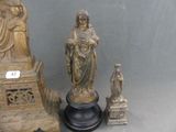 a statue of a woman holding a bird next to a statue of a man