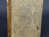 a close up of a book on a table with a black background