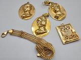 three gold - plated items including a necklace, bracelet, and pendant