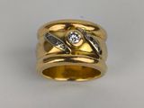 a close up of a gold ring with a diamond on it