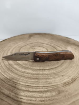 a knife that is sitting on top of a piece of wood
