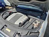 the engine of a car with its hood open in a parking lot