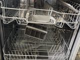 an image of a dishwasher with a lot of dishes inside of it