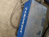 a blue box sitting on the ground next to a bike